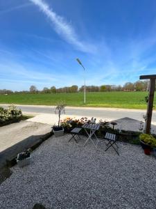 a picnic table and chairs on the side of a road at Ferienwohnung Waldseite in Bad Bentheim