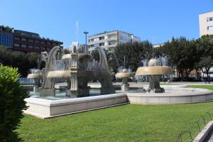 a fountain with four fountains in a park at Piazza Mazzini Apartment in Lecce