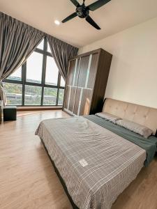 a bedroom with a bed and a ceiling fan at [Starryhomes KIDS@ Green Haven]FREE Netflix +WI-FI in Masai