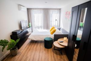 Exclusive 70m2 One-Bedroom Apartment في تيل: غرفة نوم بسرير وطاولة واريكة