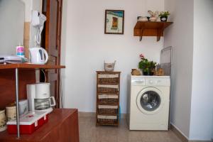 a laundry room with a washing machine and a washer at Maria Nik Psaras House in Kalymnos