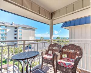 a balcony with two chairs and a table at Ocean Dunes Villa 404, 2 Bedroom, Ocean Front, Pool, Sleeps 6 in Hilton Head Island