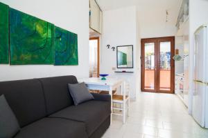 a living room with a couch and a table at Casa Vacanza Vista Mare in SantʼAlessio Siculo