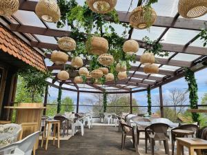a restaurant with tables and chairs and chandeliers at Apartamentai NIDA in Nida