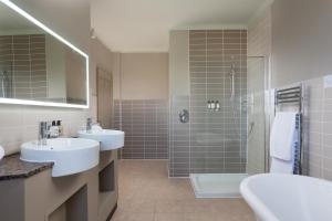 a bathroom with two sinks and a shower at Aysgarth Falls Hotel & Restaurant in Aysgarth