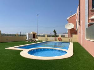 a swimming pool in a yard next to a building at Calle Carlos Primero, Roda in Roda