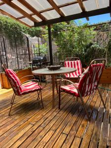 a patio with a table and chairs on a deck at Cabañas Caballieri in Pisco Elqui