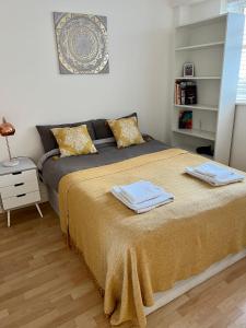 a bedroom with a bed with two towels on it at 2 bedroom near Euston, King's Cross in London