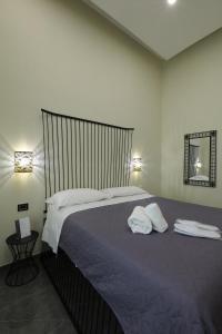 a bedroom with a large bed with towels on it at Il Salotto della Regina in Naples