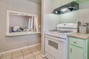 a kitchen with a white stove and a counter at Cozy & Comfy - Few blocks away from Plaza District in Oklahoma City