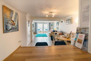 a living room with a table and a dining room at Saltwhistle Beach- Couples Retreat in Teignmouth