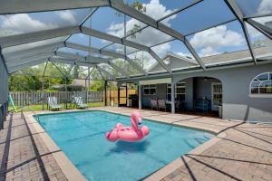 a swimming pool with a pink float in the water at Spacious Wellington Vacation Rental - Private Pool in Wellington