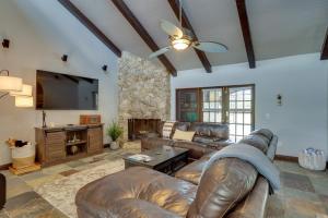 a living room with leather furniture and a flat screen tv at Spacious Wellington Vacation Rental - Private Pool in Wellington
