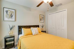 a bedroom with a yellow bed and a ceiling fan at Ruskin Vacation Rental with Screened-In Porch! in Ruskin