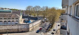 an overhead view of a city street with cars parked at Le Panoramique in Bourges