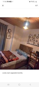 a bedroom with a bed and a couch in it at Cosy room in thornton heath in Thornton Heath