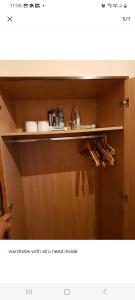 a cupboard with an open drawer with a need inside at Cosy room in thornton heath in Thornton Heath