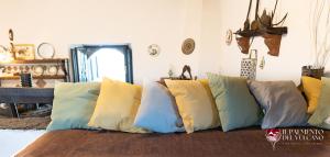 a group of pillows sitting on top of a couch at Chalet il Palmento del Vulcano in Bronte