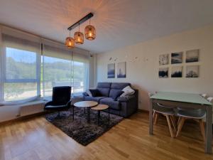 a living room with a couch and a table at Apartamento con piscina in Llanes