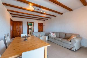 a living room with a wooden table and a couch at E-2 CALELLA DE PALAFRUGELL 8 PAX in Calella de Palafrugell