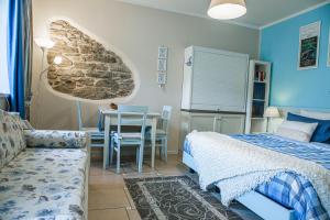 a bedroom with a bed and a table and a chair at Casa Novecento "Rooms & apartments" in Feltre