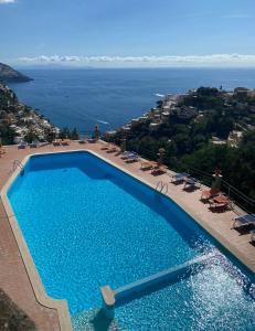 a swimming pool with a view of the ocean at Casa Gloria in Positano