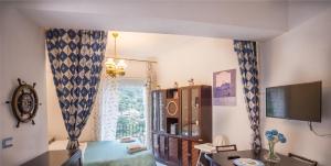 a living room with a desk and a window at Casa Gloria in Positano