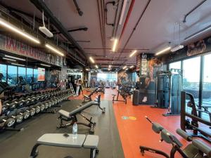 a gym with a lot of exercise equipment at VayK - Stylish One Bedroom near Marina with Full Lake View in Dubai