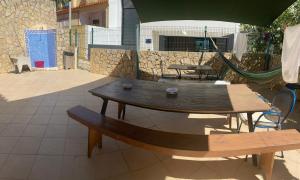 a patio with two wooden tables and benches at Lagos Marina Guest House in Lagos +16 photos
