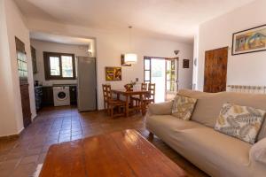 a living room with a couch and a table at Villa Miguel in Sant Rafael de Sa Creu