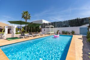 einen Pool mit einem rosa Paddelbrett in einem Haus in der Unterkunft Villa Miguel in Sant Rafael de Sa Creu