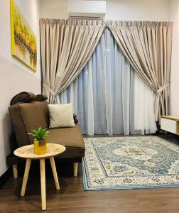 a living room with a couch and a table at Mimpi Muji Homestay Vista Bangi in Kajang +18 photos