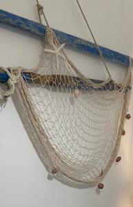 a net hanging from the side of a boat at Porto Antico in Bari