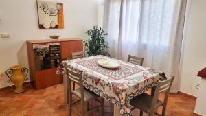 a dining room with a table with a table cloth on it at Villa Sinforosa - Mondello in Mondello