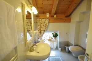 a bathroom with a sink and a toilet at Casa Novecento "Rooms & apartments" in Feltre +108 photos