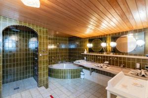a large bathroom with two sinks and a tub at Haus Anemone in Seefeld in Tirol