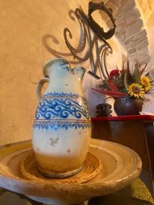 a blue and white vase sitting on a table at Appartamenti del Re in Ostuni +18 photos