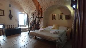 a bedroom with a bed with towels on it at Appartamenti del Re in Ostuni
