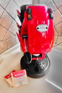 a red coffee maker sitting on top of a kitchen counter at Villa Sinforosa - Mondello in Mondello