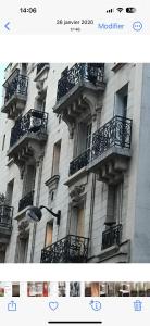 a building with balconies on the side of it at Appart douillet Paris 11 in Paris