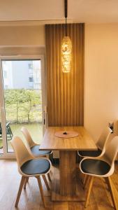 a dining room with a wooden table and chairs at Green Terrace Big Family Apartment in Wrocław