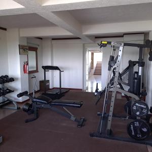 a gym with several treadmills and weights in a room at Howard Johnson by Wyndham Toluca in Toluca