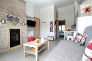 a living room with a couch and a fireplace at Beach Front Apartment in Keramoti