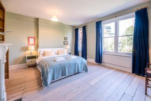 a bedroom with a bed and a large window at Hillcrest, Aldeburgh in Aldeburgh