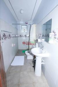 a bathroom with a sink and a toilet at Atlantic House 3 Bedroom, Naivasha in Naivasha