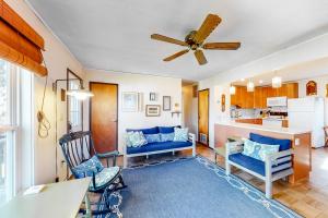 a living room with a blue couch and a ceiling fan at Captain's Choice 360 in Frisco