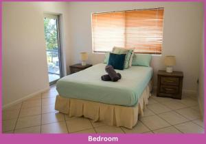 a bedroom with a bed with a teddy bear on it at The Strand Mirage in Townsville