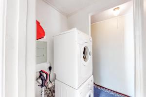 a white laundry room with a washer and dryer at Captain's Choice 360 in Frisco