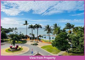 a view of a resort with palm trees and the ocean at The Strand Mirage in Townsville