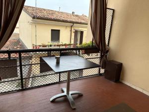 einen Tisch auf einem Balkon mit Blick auf ein Gebäude in der Unterkunft Appartamento via centro in Verona